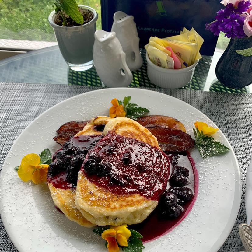 Blueberry buttermilk pancakes with good bacon.