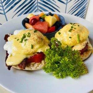 Eggs Benedict and fresh fruit.