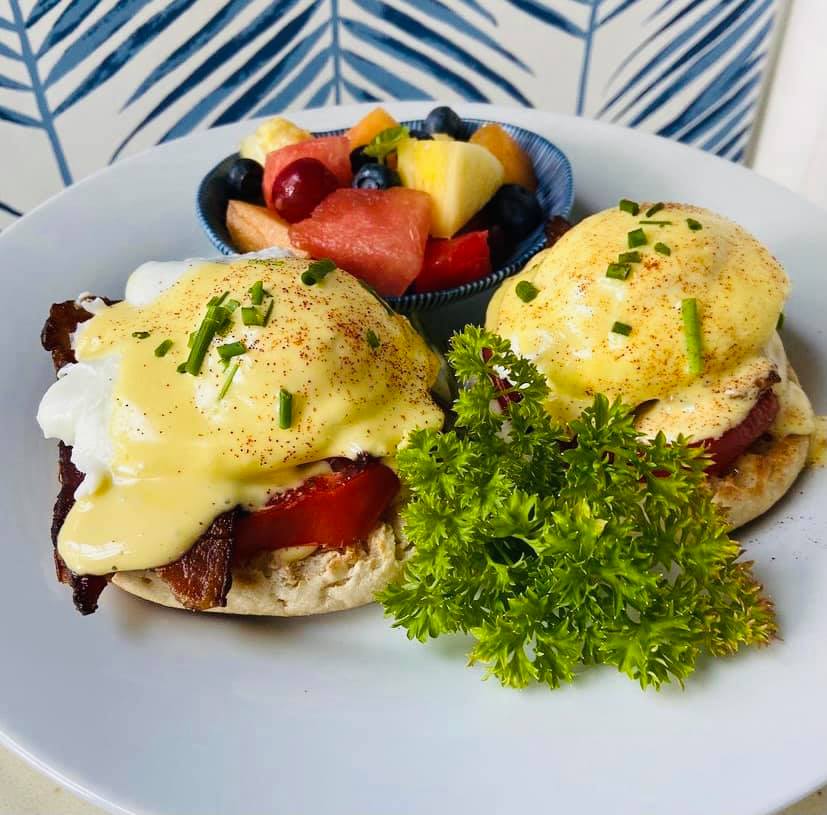 Eggs Benedict and fresh fruit.