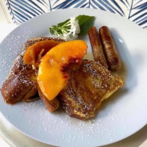 Peach glazed brioche French toast with good sausages.
